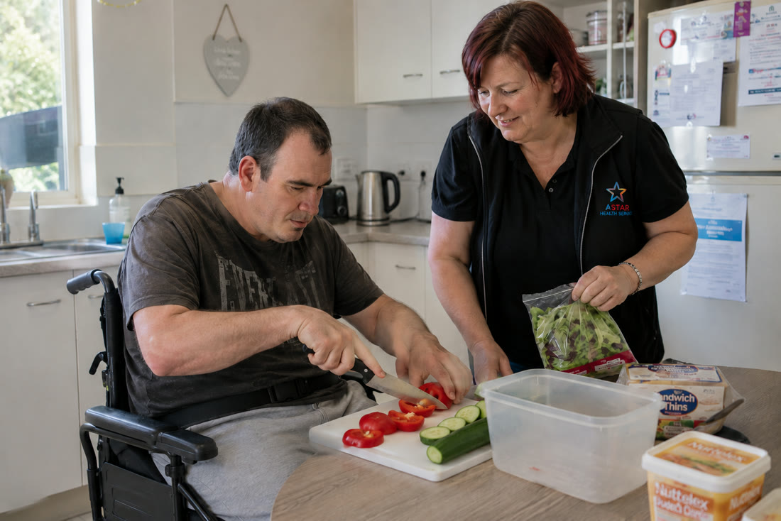 A support worker assisting a man who uses a wheelchair indoors